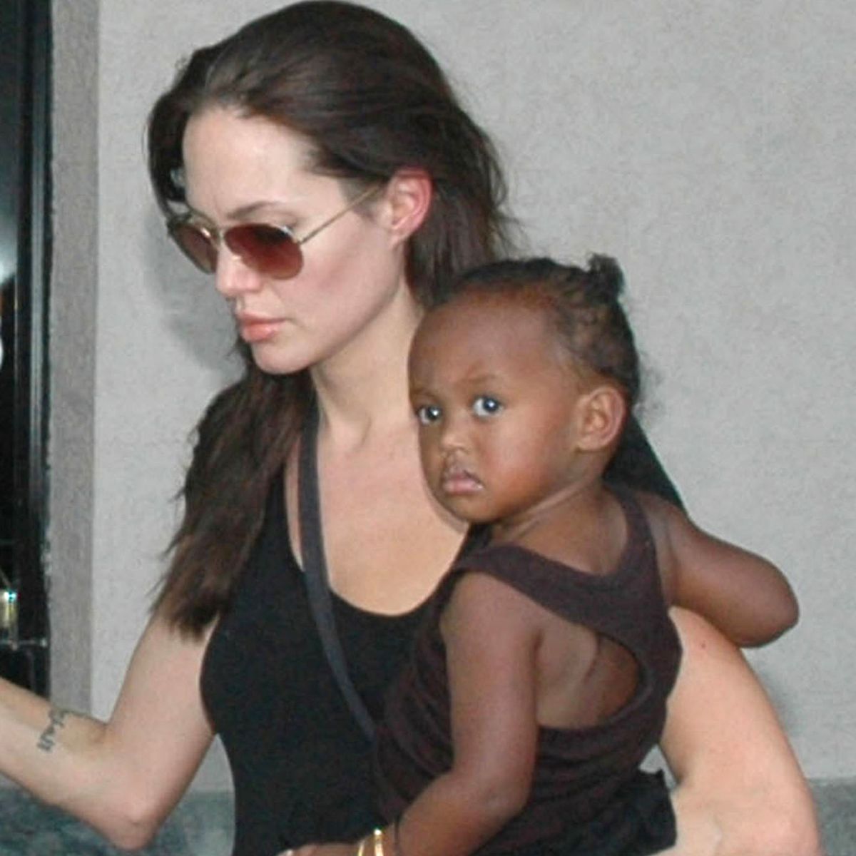 ** FILE ** In this Nov. 12, 2006 file photo, Angelina Jolie carries her Ethiopian adopted daughter Zahara, in Mumbai, India. Madonna's efforts to adopt two youngsters from Malawi have drawn the paparazzi. But she isn't alone: Westerners are increasingly seeking to bring home children from Africa as traditional sources like China and Russia cut back on adoptions by foreigners. (AP Photo/File) 