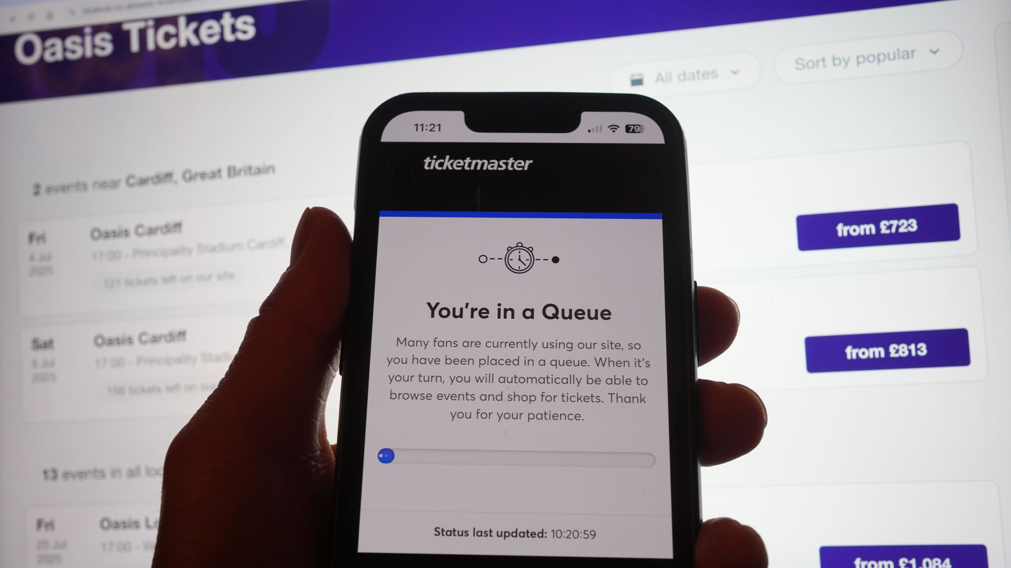 A person in a queue to access the Ticketmaster website on their phone, with the StubHub website in the background, detailing information about Oasis concert tickets for sale, in London. Oasis fans across the UK and Ireland who missed out on pre-sale tickets will be attempting to secure their place at the band's reunion concerts during Saturday's general sale. Issue date: Saturday August 31, 2024.