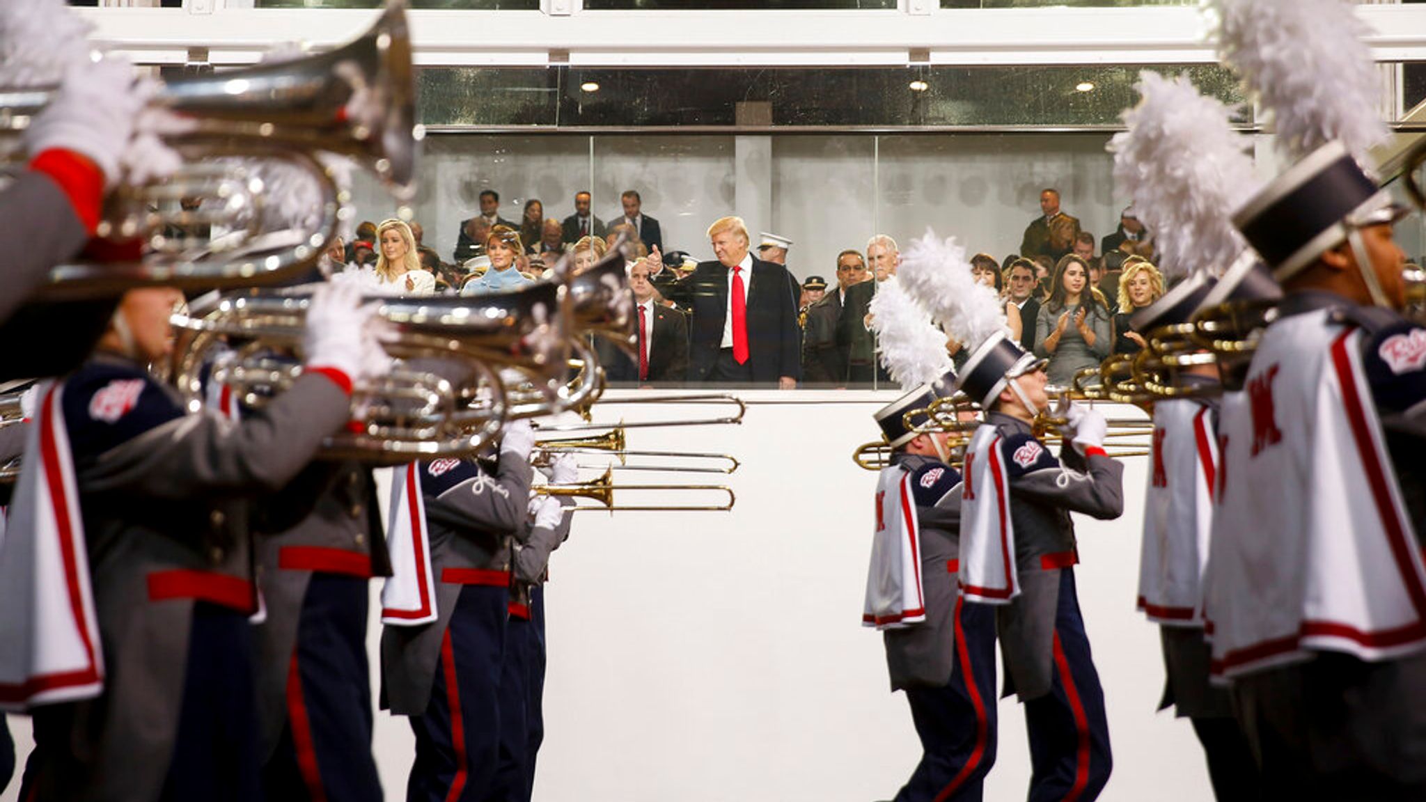 Mr Trump watches a marching band in Pennsylvania Avenue at his first inauguration