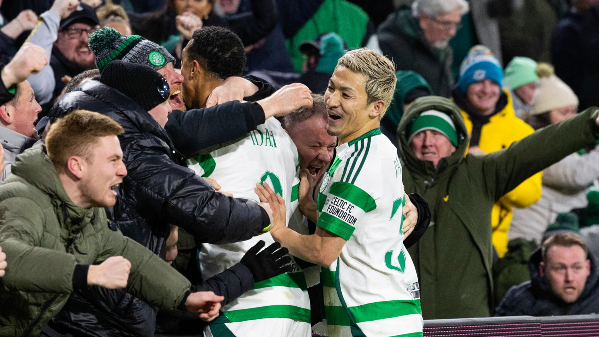 Celtic's Adam Idah (L) celebrates as his shot rebounds into the net to secure Champions League progression