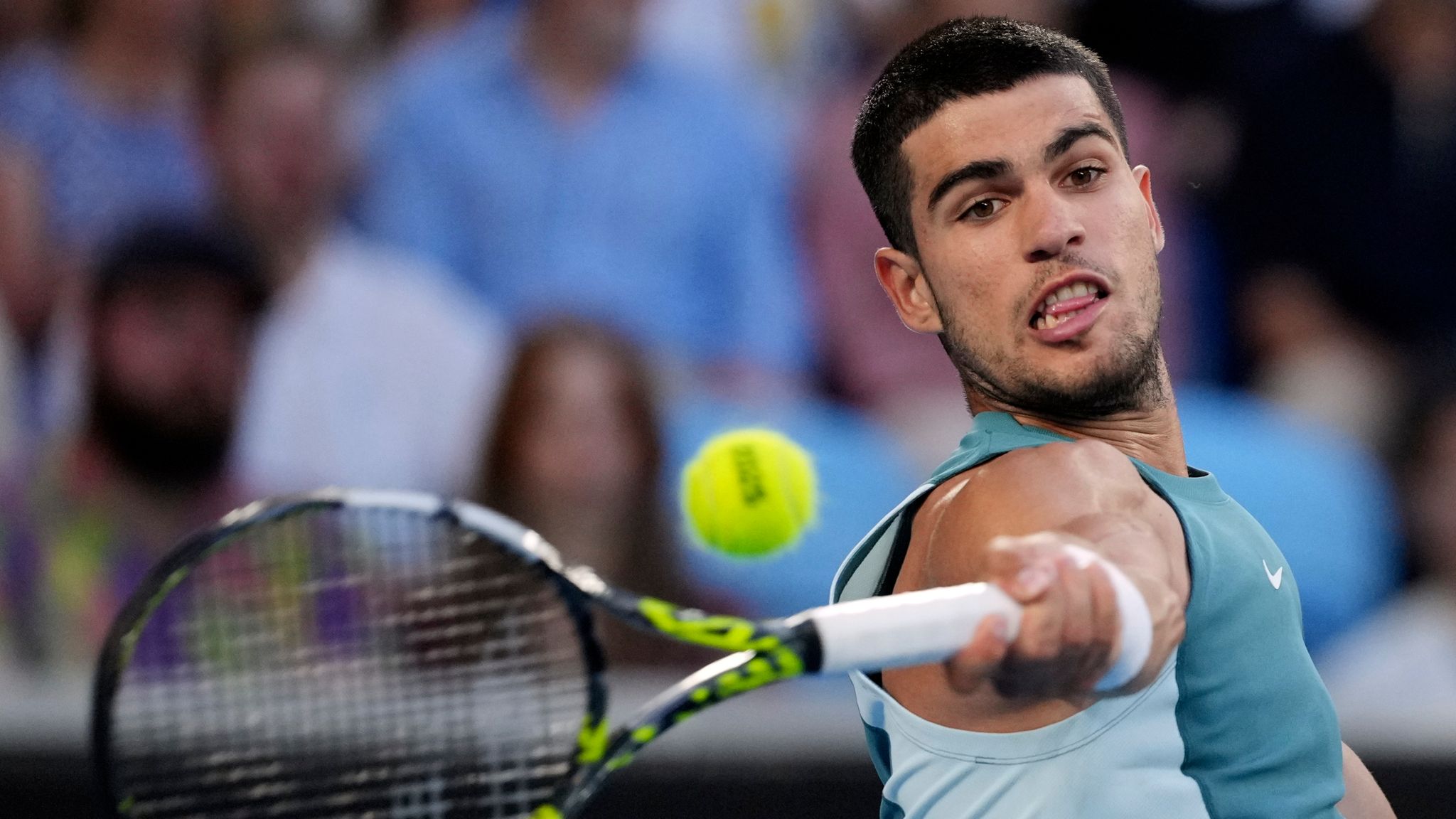 Carlos Alcaraz of Spain plays a forehand return to Alexander Shevchenko of Kazakhstan during their first round match at the Australian Open tennis championship in Melbourne, Australia, Monday, Jan. 13, 2025. (AP Photo/Vincent Thian)