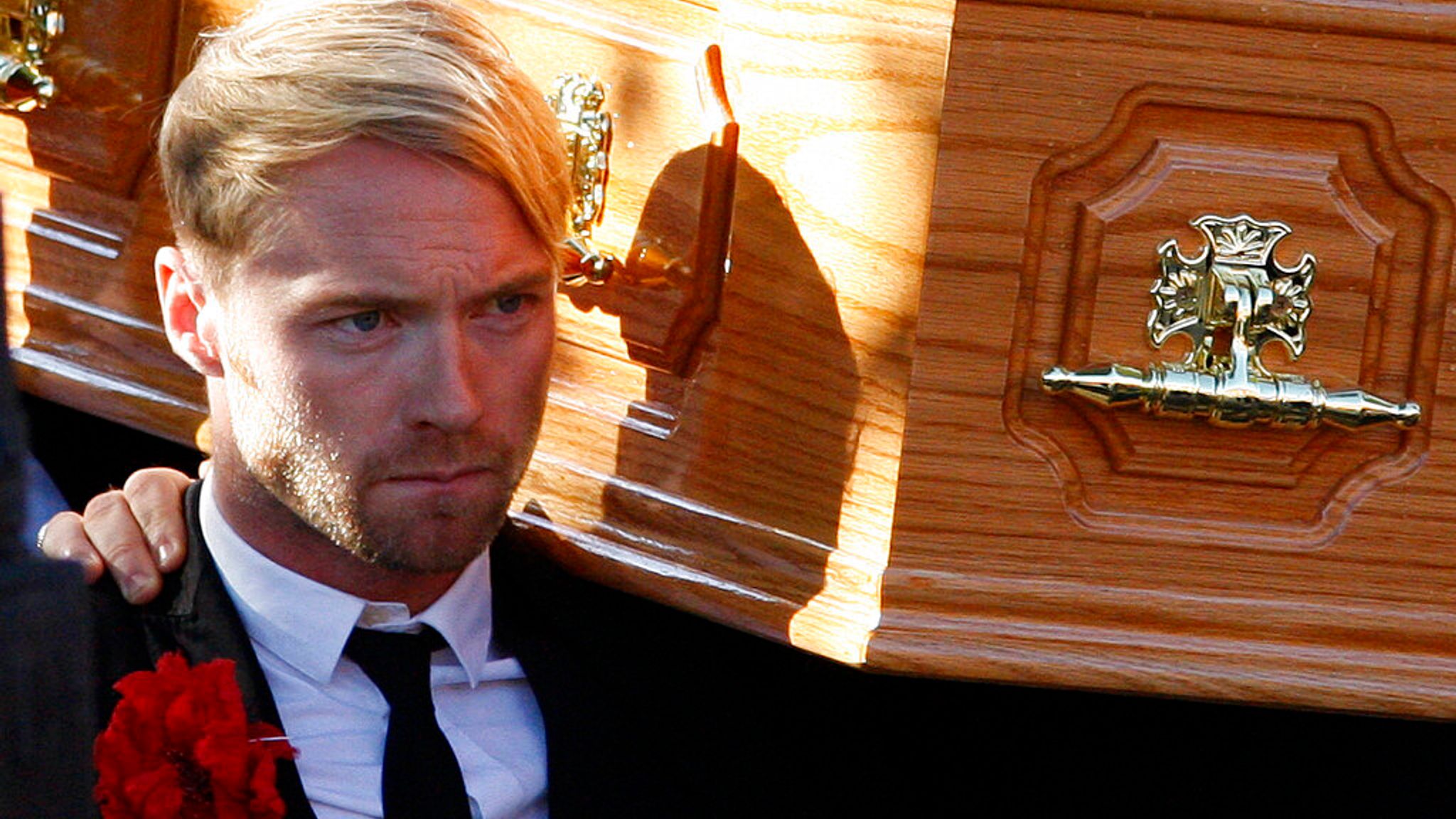 Former Irish band Boyzone, singer Ronan Keating, carries the coffin of former fellow band member Stephen Gately from St. Laurence O'Toole Church, after the funeral service, in Dublin, Ireland, Saturday Oct. 17, 2009. Gately was found dead on Saturday, Oct. 10, 2009, in a house near Port d'Andratx on the western tip of Mallorca. The singer had gone to Mallorca with his partner Andrew Cowles. The two were wed in a civil union in 2006. Autopsy results released on Tuesday showed Gately died of natur