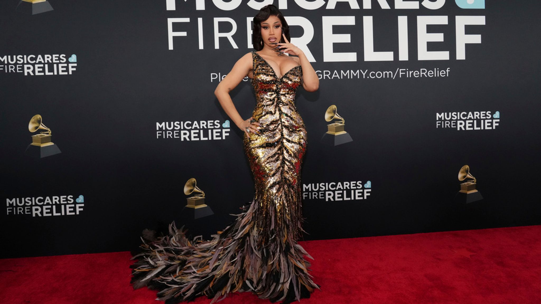 Cardi B following the feathers trend of the evening. She's presenting an award. Pic: AP